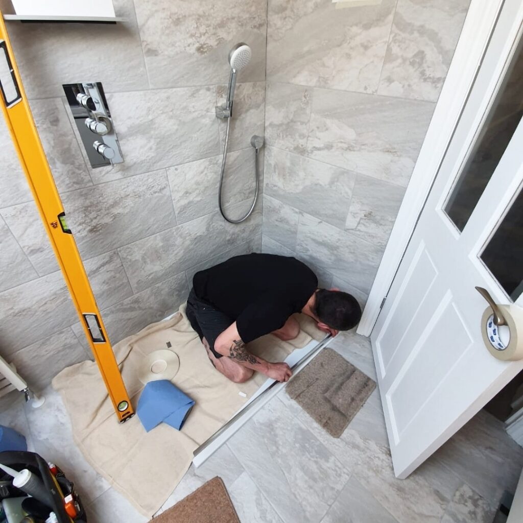 Glass Fit fitter in shower tray